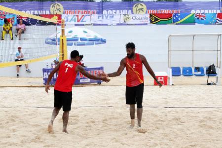 PNG's Moha Mea and Richard Kilarupa taking on Solomon Islands in their first match of the tournament.