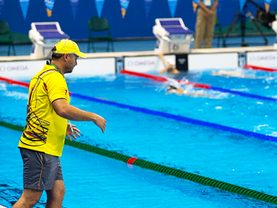 POOLSIDE: Ryan Pini pops his head up for a word with his coach, Robert Van der Zant during training in Rio. PHOTO: J. Pini/ Team PNG.