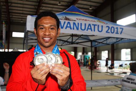 Morea Baru with his gold medals in the Snatch, Clean & Jerk and the total.